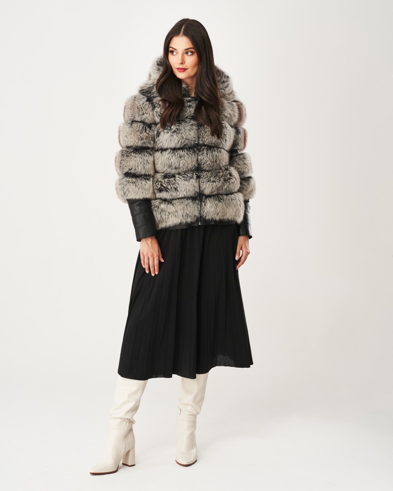Futro naturalne w odcieniach szarości z kapturem, elegancko dopasowane do czarnej spódnicy plisowanej
